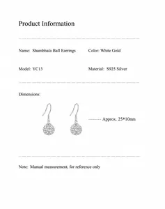 Macro detail of S925 silver sphere drop earrings with shimmering crystals and hook design