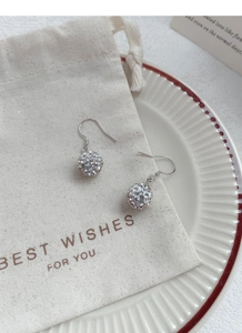 Detail view of S925 sterling silver ball drop earrings with sparkling crystal pavé stones