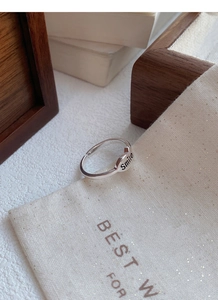 Macro detail of S925 sterling silver smile ring with elegant velvet gift pouch