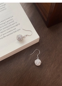 Detail shot of S925 sterling silver ball drop earrings with sparkling pavé crystals