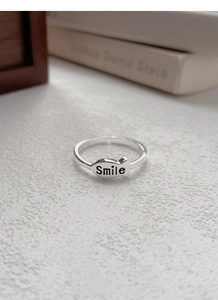 Detailed close-up of S925 silver fish-shaped ring with Smile engraving and open design