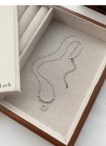 Close-up of S925 sterling silver stamp on necklace clasp and polished zirconia stones