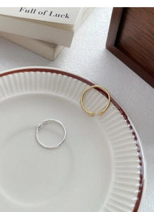 Detailed close-up of S925 sterling silver twisted rings in gold and silver finishes