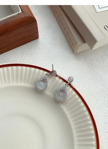 Detail view of S925 silver teardrop earrings with green chalcedony and pavé zircons