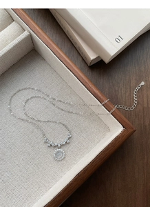 Detailed close-up of S925 sterling silver smiling zircon necklace with a macro view of the hallmark