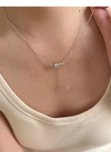 Close-up of S925 sterling silver star fringe necklace with sparkling cubic zirconia stones