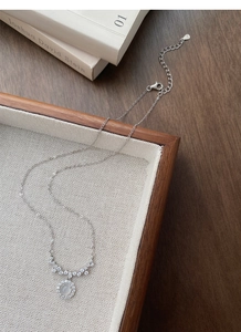 Macro view of S925 silver necklace featuring a moonstone pendant with zircon halo