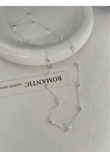 Detail of S925 sterling silver station necklace with bezel-set cubic zirconia crystals