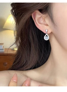 Close-up of S925 silver teardrop earrings with pale green chalcedony and micro-pave zircons