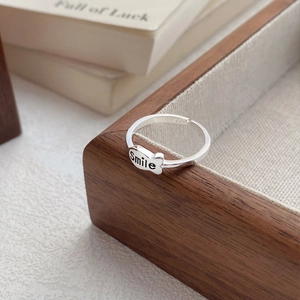 Minimalist S925 sterling silver open ring with smile heart design on wood tray