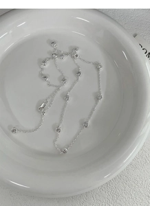Detail of silver S925 sterling silver chain with bezel-set round cubic zirconia stones