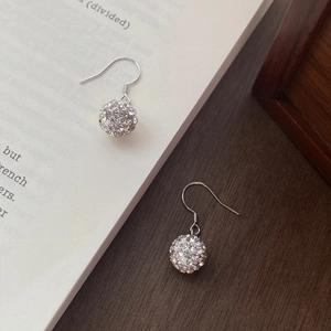 S925 silver hook earrings with shimmering rhinestone ball pendants on a wooden table