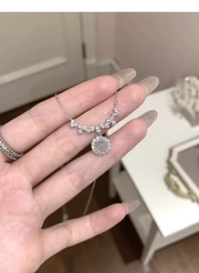 Close-up of S925 silver necklace with round light purple gemstone and zircon cluster