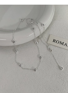 Detailed macro view of S925 sterling silver chain with bezel-set sparkling round zircons