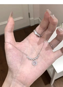 Close-up of S925 sterling silver necklace with a pink opal pendant and sparkling diamonds