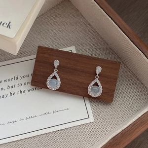 Elegant S925 sterling silver waterdrop earrings with white chalcedony on wood stand