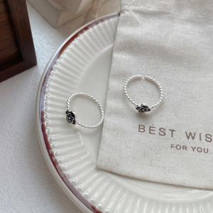 Elegant S925 sterling silver open ring featuring a black enamel flower and twisted band