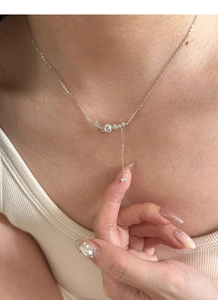 Macro shot of S925 silver Y-shaped tassel necklace with stars and zircon pendant