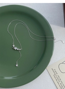 Macro shot of S925 silver star tassel pendant necklace with sparkling zircon details