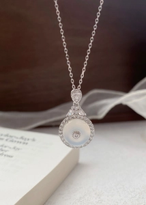 Detailed macro view of S925 silver necklace with white chalcedony pendant and crystals