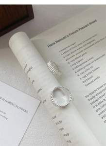Detailed shot of two S925 sterling silver rings with irregular texture and beaded edge