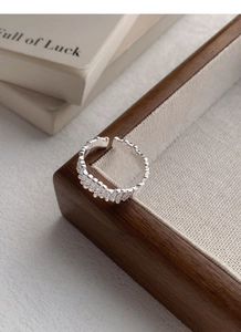 Close-up of S925 sterling silver ring with irregular vertical texture and adjustable band