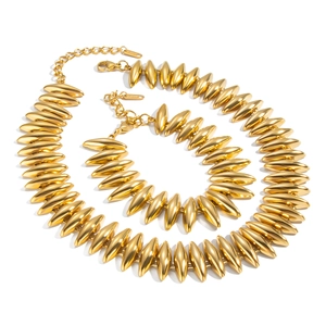 Polished gold stainless steel jewelry set featuring bullet shaped necklace and bracelet links