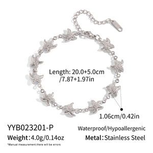 Macro detail of silver stainless steel starfish bracelet links showing polished finish