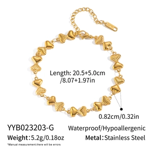 Detailed view of 18K gold plated stainless steel heart chain with lobster clasp and tag