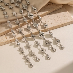 Detailed view of silver sea-themed bracelets with starfish and shell charms on satin