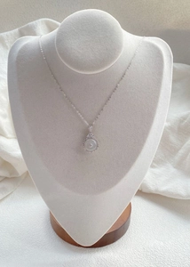 Close-up of S925 sterling silver necklace featuring white chalcedony on jewelry bust