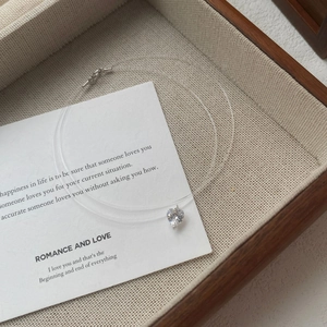 Elegant S925 silver heart zircon invisible fishing line necklace on a wooden jewelry box