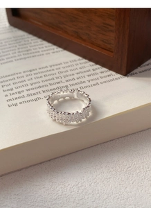 Macro shot of S925 sterling silver ring showing irregular lava texture and hallmark