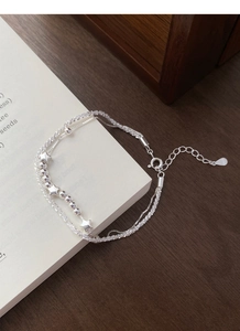 Detail of S925 sterling silver double-layer bracelet with stars and lobster clasp