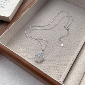 Elegant S925 sterling silver necklace featuring a round white chalcedony pendant with zircons
