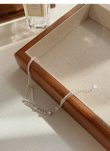 Detail view of double-layered S925 silver star bracelet with beads on display tray