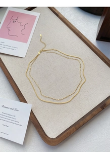 Detail van een gouden dubbellaagse sterling zilveren ketting met karabijnsluiting en verlenging