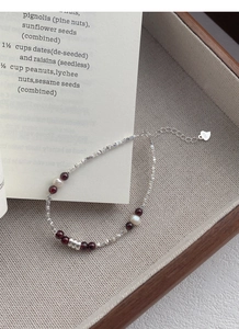 Detailed macro view of S925 silver bracelet with red garnets and natural pearls