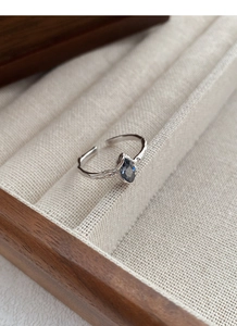 Macro shot of 925 silver irregular branch texture ring with marquise blue sapphire gemstone
