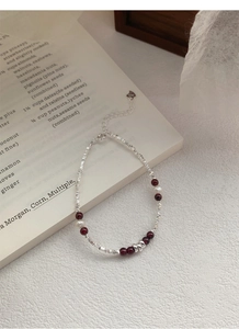 Detail of S925 sterling silver stamp on garnet beaded bracelet with pearls