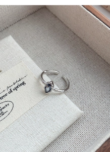 Detailed macro view of the irregular hammered texture on this silver sapphire open ring