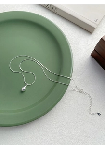 Detail of S925 sterling silver water drop pendant showing the hallmark and star engraving