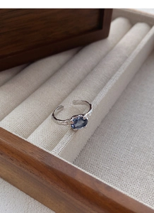 Close-up of S925 silver irregular ring with blue zircon and hand-hammered texture