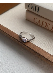 Macro detail of S925 sterling silver hammered texture ring with purple zircon stone