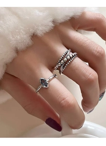 Detailed view of 925 silver rings set with blue sapphire and irregular hammered texture