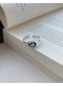 Detailed view of S925 silver ring with hammered texture and oval blue gemstone