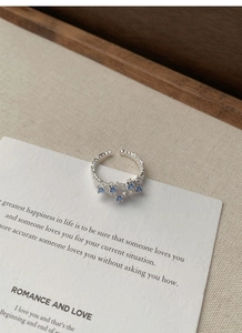 Detailed macro view of S925 silver hammered ring with five square blue zircon stones