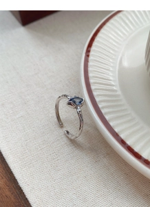 Detail view of adjustable silver sapphire ring with an organic branch texture design