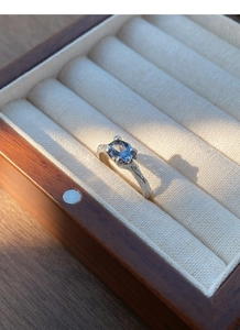Detailed close-up of S925 silver ring with blue zircon in a luxury jewelry box