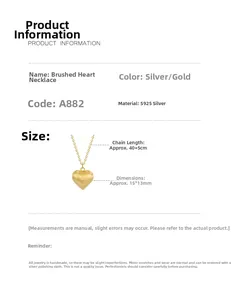 Macro detail of S925 sterling silver heart pendant with brushed texture and size measurements